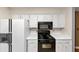 Kitchen featuring white cabinets and a black gas range and microwave at 916 Forest Pointe Way, Jonesboro, GA 30238