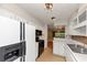 Open kitchen featuring white cabinets, tile backsplash, and black appliances at 916 Forest Pointe Way, Jonesboro, GA 30238