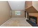 Well-lit living room with large windows, neutral carpet, and a fireplace adding warmth at 916 Forest Pointe Way, Jonesboro, GA 30238