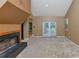 Spacious living room with a fireplace, neutral carpet, and sliding glass doors that provide ample natural light at 916 Forest Pointe Way, Jonesboro, GA 30238