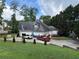 Beautiful home with a three-car garage, stone accents, and mature trees at 3393 Childers Ne Rd, Roswell, GA 30075