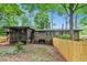 View of the fenced backyard with a screened porch and the exterior brick elevation of the home at 3431 Alcan Way, Tucker, GA 30084