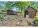 View of the fenced backyard with mature trees and landscaping plus the shed at 3431 Alcan Way, Tucker, GA 30084