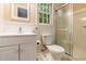 Bathroom features a shower, toilet, sink with a mirror, and a window at 3431 Alcan Way, Tucker, GA 30084