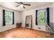 Bedroom with hardwood floors, a window with dark curtains, and a mirror at 3431 Alcan Way, Tucker, GA 30084
