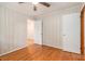 An empty bedroom featuring a window, hardwood floors, and panelled walls at 3431 Alcan Way, Tucker, GA 30084