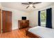 Bedroom features a bed, wooden dresser, window with curtains, and hardwood floors at 3431 Alcan Way, Tucker, GA 30084