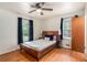 Bedroom features a bed, window with dark curtains, a ceiling fan, and hardwood floors at 3431 Alcan Way, Tucker, GA 30084