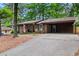 Traditional brick home with a covered carport and mature trees offering shade at 3431 Alcan Way, Tucker, GA 30084