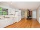 Open kitchen and dining area with a wood-burning stove and hardwood floors at 3431 Alcan Way, Tucker, GA 30084