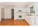 The kitchen features white appliances, light wood floors and an open view of the backyard at 3431 Alcan Way, Tucker, GA 30084
