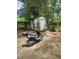Backyard area with a scooter, storage shed, and mature trees providing shade at 3503 Ten Oaks Ct, Powder Springs, GA 30127