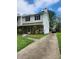 Traditional two-story townhome with vinyl siding, stone accents, and a paved driveway under a partly cloudy sky at 3503 Ten Oaks Ct, Powder Springs, GA 30127