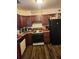 Functional kitchen with wood cabinets, modern appliances, and wood-look flooring at 3503 Ten Oaks Ct, Powder Springs, GA 30127