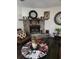 Cozy living room featuring a stone fireplace, dark wood floors, and unique decorative accents at 3503 Ten Oaks Ct, Powder Springs, GA 30127