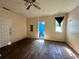 A bedroom with wood floors, paneled walls, an overhead fan, and an attached bathroom at 3517 Plunkett Road Rd, Stonecrest, GA 30038