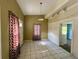 Bright dining room featuring neutral walls, tile floors, updated lighting, and classic curtain accents near the entry at 3517 Plunkett Road Rd, Stonecrest, GA 30038