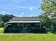 Charming single-story home with a covered front porch and lush landscaping at 3517 Plunkett Road Rd, Stonecrest, GA 30038