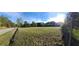 Expansive plot of land showcasing its potential for development, featuring green fields and easy road access under a sunny sky at 3517 Plunkett Road Rd, Stonecrest, GA 30038