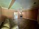 Cozy living room featuring hardwood floors, fireplace, ceiling fan, and a comfortable sofa, ready for relaxation and gatherings at 3517 Plunkett Road Rd, Stonecrest, GA 30038