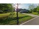 Scenic view of a home with a well-maintained lawn and a peaceful country road, showing a tranquil living environment at 3517 Plunkett Road Rd, Stonecrest, GA 30038