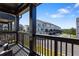 Balcony view of a townhouse complex and a scenic tree lined street, with a seating area at 823 Mackay Crk, Woodstock, GA 30188