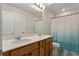 Bathroom featuring double sinks, a white countertop, a decorative shower curtain, and a modern design at 823 Mackay Crk, Woodstock, GA 30188