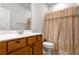 Bathroom with a single sink vanity and a shower with gold curtain at 823 Mackay Crk, Woodstock, GA 30188