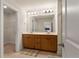 Double vanity bathroom featuring a large mirror, cabinet storage, and access to both a closet and shower at 823 Mackay Crk, Woodstock, GA 30188