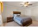 Comfortable bedroom with a wooden bed frame, nightstands, a ceiling fan and natural light from the window at 823 Mackay Crk, Woodstock, GA 30188