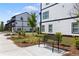 Community green space with benches, landscaping, and modern townhomes at 823 Mackay Crk, Woodstock, GA 30188