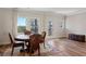 Cozy dining area with wood table, four chairs, and natural light from large windows at 823 Mackay Crk, Woodstock, GA 30188