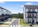 Townhouse complex featuring white siding with black trim and ample parking spaces at 823 Mackay Crk, Woodstock, GA 30188