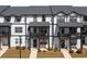 Modern townhouse with black and white trim, front porch, and well-manicured lawn at 823 Mackay Crk, Woodstock, GA 30188