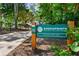 Sign for Greenprints Regional Trailway System Noonday Creek Trail surrounded by lush greenery at 823 Mackay Crk, Woodstock, GA 30188