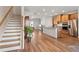 Open living space with kitchen, dining area, and stairs, featuring hardwood floors and modern design at 823 Mackay Crk, Woodstock, GA 30188