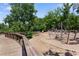 Playground with wood bridge leading to fun play structures surrounded by lush green trees at 823 Mackay Crk, Woodstock, GA 30188