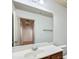 Bright bathroom featuring a vanity with a white countertop and a large mirror at 1071 N Village Dr, Decatur, GA 30032