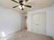 Well-lit bedroom with carpet, ceiling fan, and closet with double doors at 1071 N Village Dr, Decatur, GA 30032