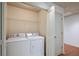 Laundry room featuring a white washer and dryer and a wire shelf at 1071 N Village Dr, Decatur, GA 30032