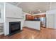 Open living space with a fireplace and seamless transition to the kitchen, featuring hardwood floors at 1071 N Village Dr, Decatur, GA 30032