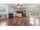 Open concept living area with a cozy fireplace, hardwood floors, and an adjacent modern kitchen at 1071 N Village Dr, Decatur, GA 30032