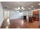 Well-lit living space with hardwood floors, fireplace, and seamless flow to the kitchen and dining areas at 1071 N Village Dr, Decatur, GA 30032