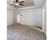 The primary bedroom features neutral carpet, large windows and a trey ceiling with fan at 1071 N Village Dr, Decatur, GA 30032