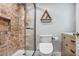 Modern bathroom featuring a tiled shower with glass door, and updated toilet and vanity at 199 14Th Ne St # 402, Atlanta, GA 30309