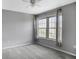 This bedroom features neutral walls, a ceiling fan, and a large window providing ample natural light at 199 14Th Ne St # 402, Atlanta, GA 30309