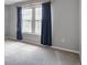 Bedroom features soft gray walls, carpeted floors, and a window with dark blue drapes at 199 14Th Ne St # 402, Atlanta, GA 30309