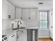 Well-lit kitchen with stainless steel appliances and white cabinetry at 199 14Th Ne St # 402, Atlanta, GA 30309