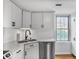 Updated kitchen featuring white cabinets, stainless steel appliances, and white backsplash at 199 14Th Ne St # 402, Atlanta, GA 30309