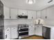 Modern kitchen with white cabinets, stainless steel appliances, and hardwood floors at 199 14Th Ne St # 402, Atlanta, GA 30309